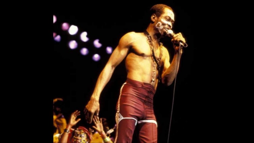 FELA HOLDING A MICROPHONE AND SINGING
