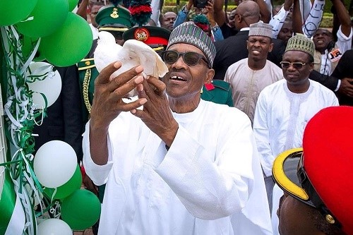 NIGERIAN PRESIDENT MOHAMMAD BUHARI, RELEASING A DOVE, DURING NIGERIA`S 57TH INDEPENDENCE CELEBRATION