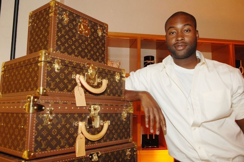 MICHAEL KNIGHT STANDING NEXT TO LOUIS VUITTON LUGGAGE